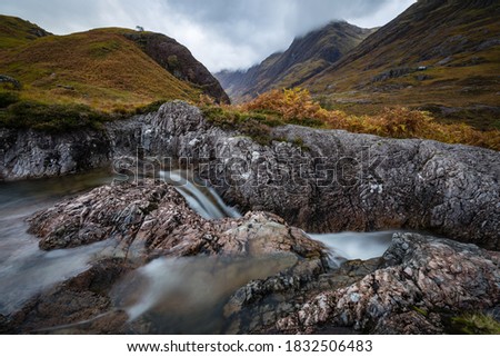 long exposure shot of the waterfalls in glencoe near lthe entrance to glencoe and rannoch moor in the argyll region of the highlands of scotland during summer