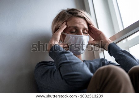 Woman indoors at home feeling stressed, mental health and coronavirus concept. Royalty-Free Stock Photo #1832513239