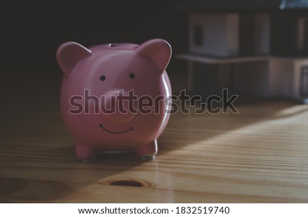 Piggy Bank on wood table.money saving financial concept.