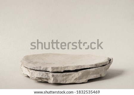Background for cosmetic products of natural gray color. Stone podium on a gray background. Front view.