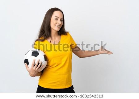 Young football player woman over isolated white background extending hands to the side for inviting to come
