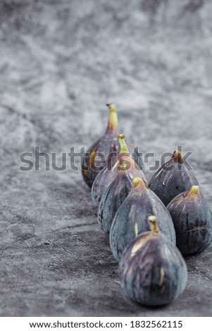 Purple ripe figs on a marble background. High quality photo