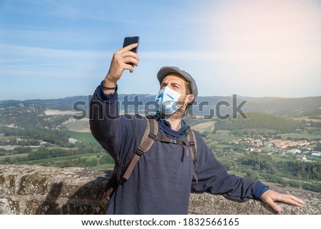 A man taking a picture of himself with a panoramic view.