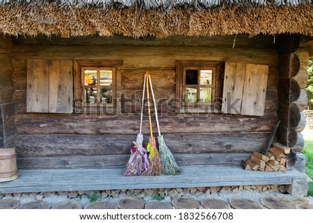 three different brooms of witches stand at the house