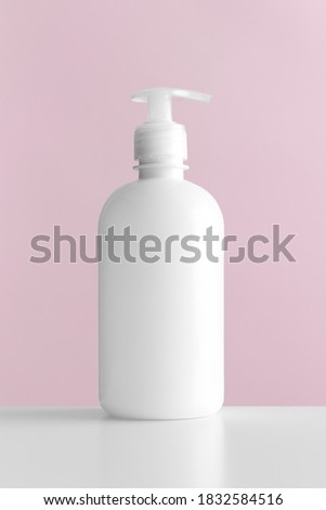White cosmetic liquid soap dispenser bottle mockup with pink background.