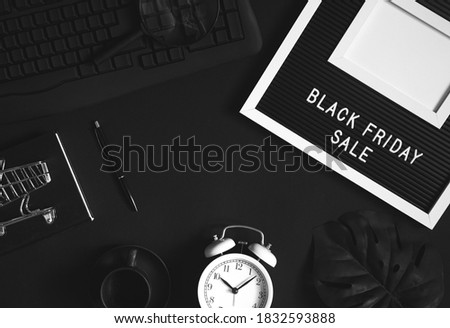 Black Friday sale. black composition top view and flat lay. white alarm clock and keyboard on desktop