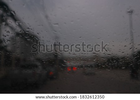 Rain background on the windshield on the road