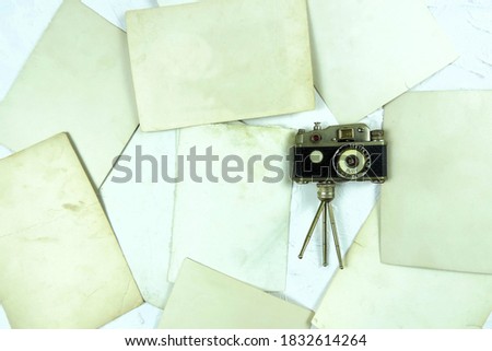     flat lay   vintage retro camera and old photos back side  , copy space          