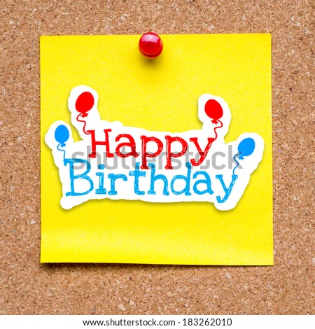 Happy Birthday, pinned on cork bulletin board on yellow paper