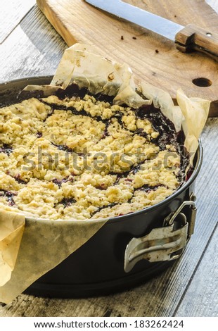 Crumble pie with black currants on baking paper From series Summer desserts