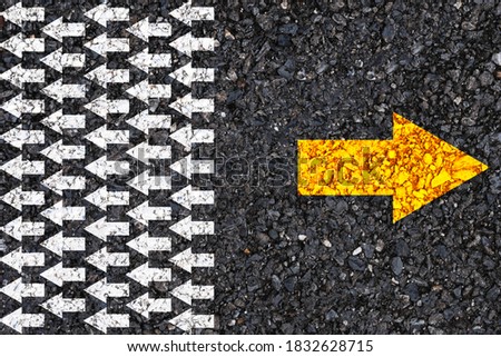 Different thinking and Business and technology disruption concept. Yellow arrow opposite  direction with white arrow on road asphalt. 