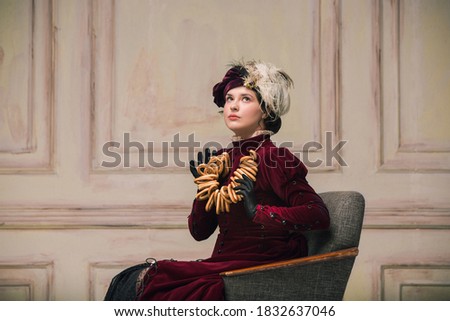 Bagels, tasty break. Modern trendy look of Portrait of an Unknown Woman. Retro style, comparison of eras concept. Beautiful caucasian female model like classic art character, old-fashioned.