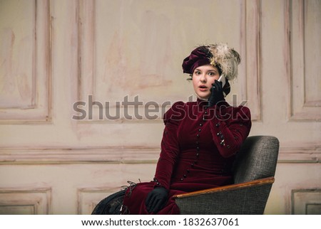 Talking phone. Modern trendy look of Portrait of an Unknown Woman. Retro style, comparison of eras concept, flemish style. Beautiful caucasian female model like classic art character, old-fashioned.