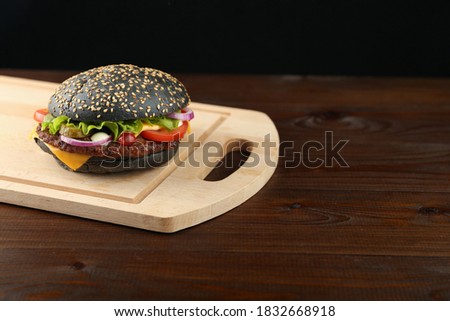 black burger on dark background