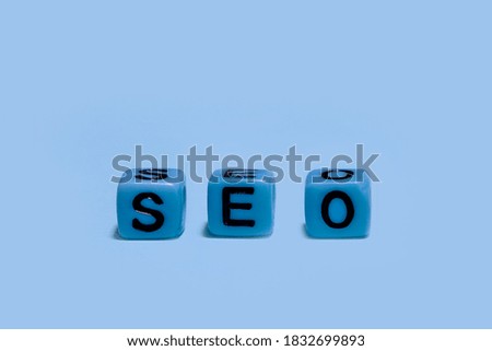 word SEO on blue color cube 