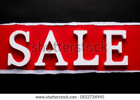 Wooden text  word "SALE" with copy space on red background. Black friday or online shopping concept.