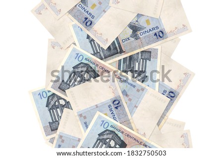 10 Tunisian dinars bills flying down isolated on white. Many banknotes falling with white copyspace on left and right side