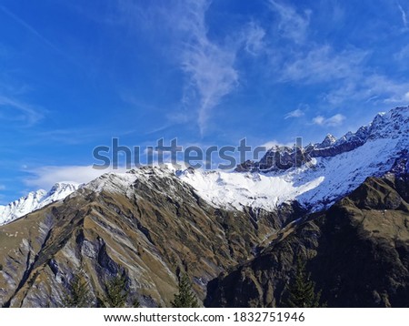 Snowy peaks in first snow shower of Autumn in Sardona Massif in Glarner Alps in Switzerland