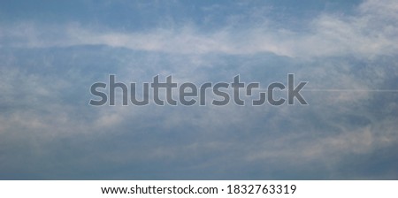 blue sky with clouds and an airplane