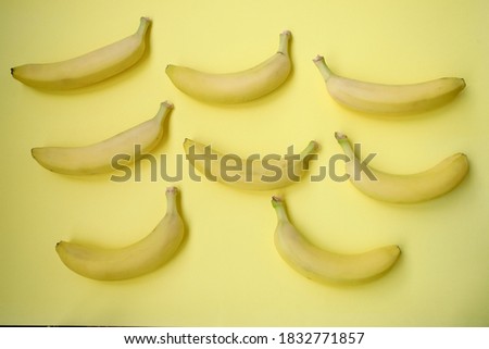 Fresh Banana on yellow background. Seamless pattern with bananas. Tropical abstract background. Banana on yellow background