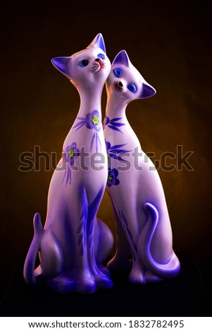 SURABAYA, EAST JAVA, INDONESIA, OCTOBER 13, 2020, a pair of cats made of ceramic with a gradient background