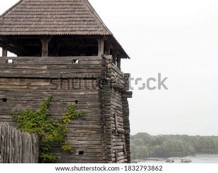 watchtower of an ancient wooden fortress on a fjord background