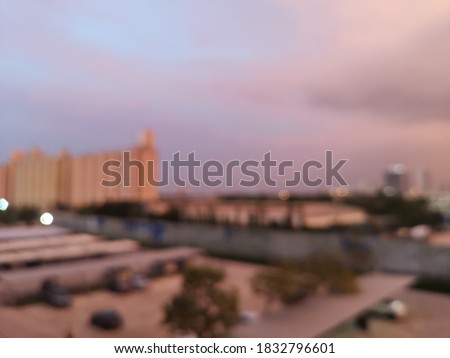 Blur focus of Aerial view of warehouse storages or industrial factory or logistics center from above. Top view of industrial buildings and trucks