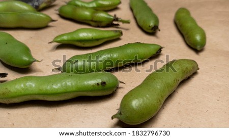 photo of green bean pods. Beans on craft paper. Healthy lifestyle, legumes.
