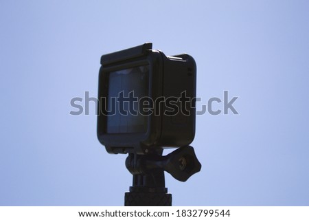 Video camera used to photograph sports and adventures with blue background