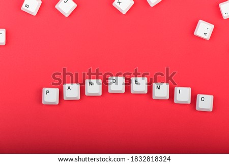 Keyboard keys. Word "pandemic" made from keys isolated. White keyboard keys on red background. Top view. Close up
