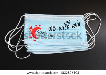 WE WILL WIN against covid-19 outbreak around the world. blue surgical medical mask against coronavirus with write We Will Win and Covid 19 Logo. Royalty-Free Stock Photo #1832826103