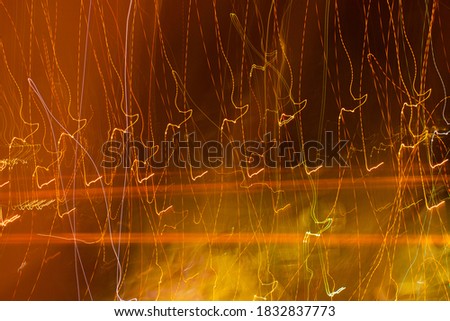 A rich textured background.Fiery orange-red. Effect of movement, energy. Streaks of light. Summer.