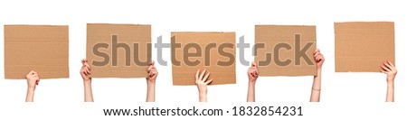 Posters of cardboard in his hands. Isolated on white. Set. Copy space. Royalty-Free Stock Photo #1832854231