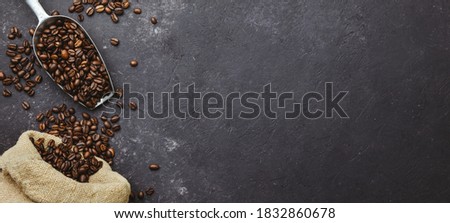 coffee beans in a sack on dark background, top view