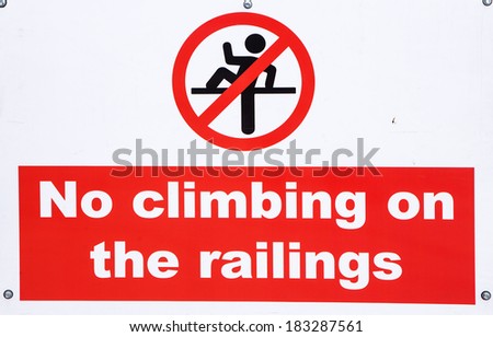 A sign warning people not to climb on the railings