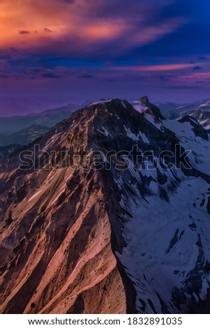 Aerial landscape view of Garibaldi Mountain. Dramatic Sunset Artistic Render. Picture taken from an airplane between Squamish and Whistler, North of Vancouver, British Columbia, Canada.