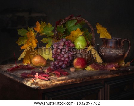 Autumn still life with maple leaves and fruits