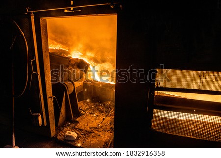 Tank pours liquid metal in the molds at the steel mill Royalty-Free Stock Photo #1832916358