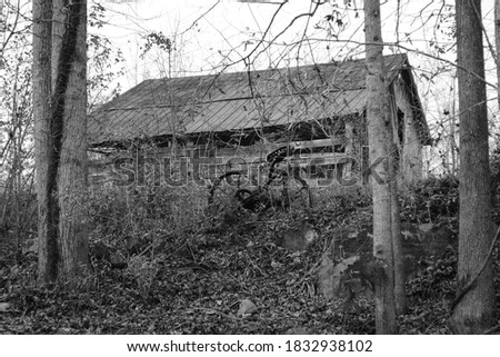A gorgeous black and white vintage antique picture of a old barn 