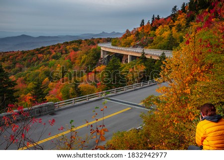 Nature photographer documenting the fall colors along the Linn Cove Viaduct Blue Ridge Parkway of North Carolina