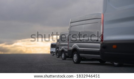 Commercial Vans in row on dealership parking Royalty-Free Stock Photo #1832946451
