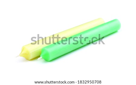 Two Candles isolated on a white background. Green candle