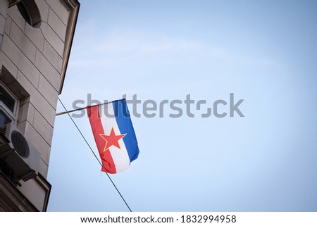 Yugoslav flag, with the red star of the communist socialist federal republic of yugoslavia (SFRY), waving in Belgrade, the former capital city of this disappeared state.

 Royalty-Free Stock Photo #1832994958