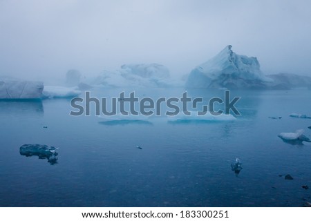 Beatufil vibrant picture of icelandic glacier and glacier lagoon with water and ice in cold blue tones 