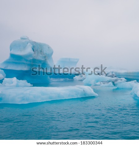 Beatufil vibrant picture of icelandic glacier and glacier lagoon with water and ice in cold blue tones 
