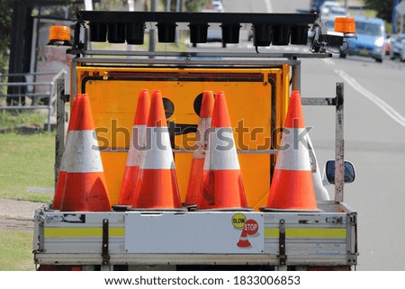 Traffic cones and signs in the back of a truck