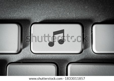 Music button on a neat white keyboard