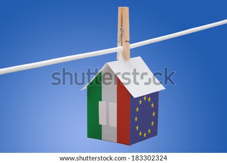 concept - Italy, Italian and EU flag painted on a paper house hanging on a rope