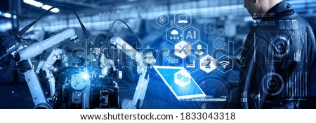 Smart industry robot arms for digital factory production technology showing automation manufacturing process of the Industry 4.0 or 4th industrial revolution and IOT software to control operation . Royalty-Free Stock Photo #1833043318