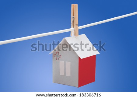 concept - Malta, Maltese flag painted on a paper house hanging on a rope